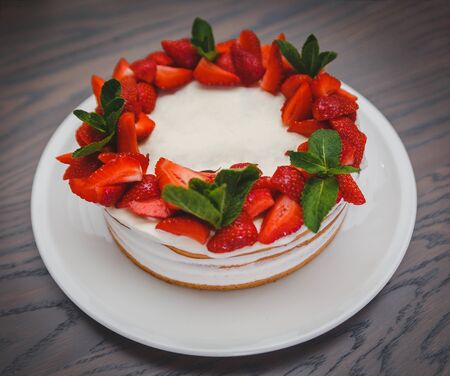unreal delicious strawberry red and white beautiful designer sweet cake pie on white plate. Cake with place side in the middle where you can write something. photo img example for cake shopの写真素材