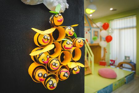 toy bees hand made by children hangs on the wall. education centre school or kindergarten preschool....
