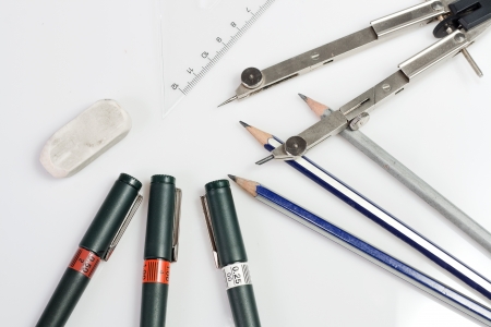 Background made of ruler, drawing compass, technical pens, pencils, rubber gum isolated on white...