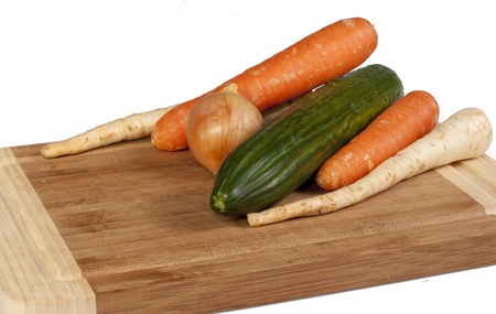 Vegetables on cutting board isolated on white backgroundの写真素材