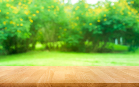 Real wood table top texture on leaf tree garden background.For create product display or design key visualの写真素材
