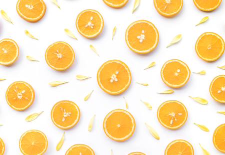 Top view of orange slice with flower petal on white background.fruit and summer concept idea.flat...