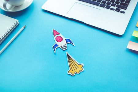 Business start up concept with rocket on desk table color.Creativity innovation ideasの写真素材