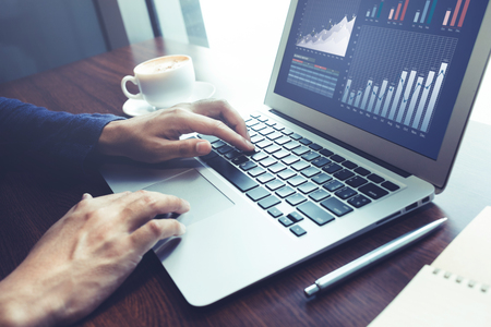 Male working with computer laptop on wood bar in cafe.Business lifestyle concepts ideasの写真素材