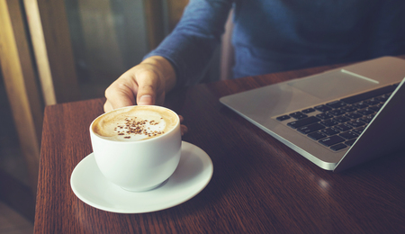 Businessman working with laptop and coffee cup on desk table in cafe shop.Business inspiration and drinking concepts ideasの写真素材