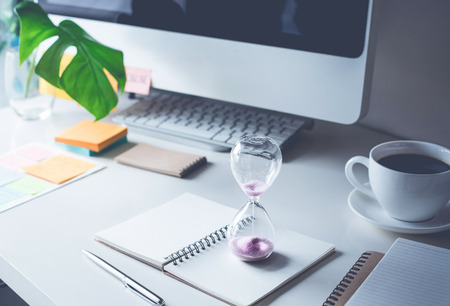 hourglass with worktable office.Time,motivation concepts