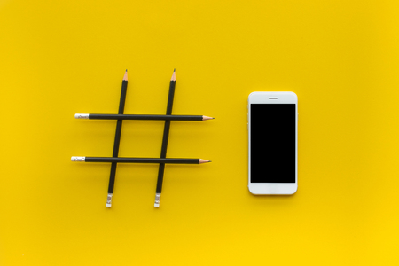 Social media and creativity concepts with Hashtag sign made of pencil and smartphone.digital...