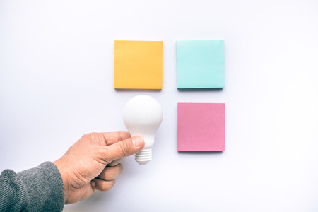Creativity inspiration concepts with lightbulb and notepaper in colorful