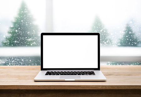 Computer,laptop with blank screen on snowfall in white.christmas winter backgroundsの写真素材