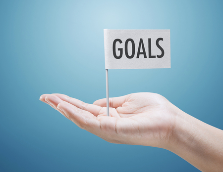 Goals concepts with flag on handの写真素材