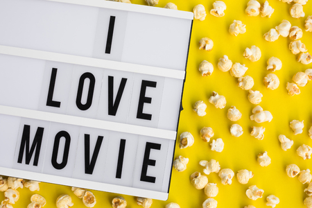 I love movie text on light box with pop corn on pastel color background.Food and snack concepts ideas.Minimal styleの写真素材