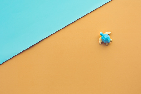 Baby turtle on paper art sea, beach background.Environment and animal concepts ideas.Above imagesの写真素材