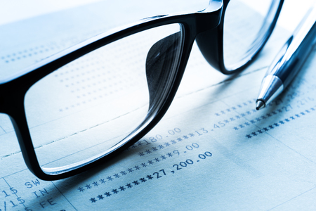 Pen and glasses on financial banking data.For business and financial,investment concept.の写真素材