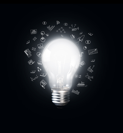 Glowing light bulb with business icons.creativity inspiration concept ideas.の写真素材