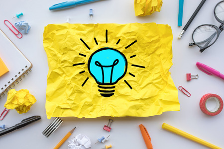 Inspiration creativity concepts with lightbulb in paper crumpled ball on worktable.Business ideas...