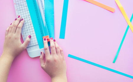 Young woman making paper art in colorful with pink space background.Hobby decoration design