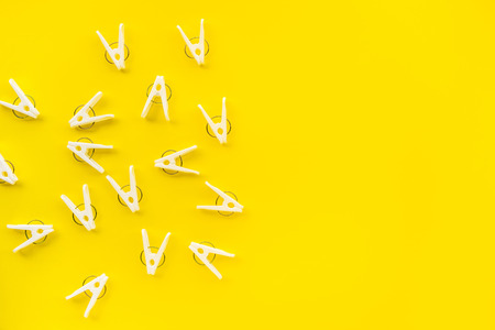 clothespins on yellow color background,copy space