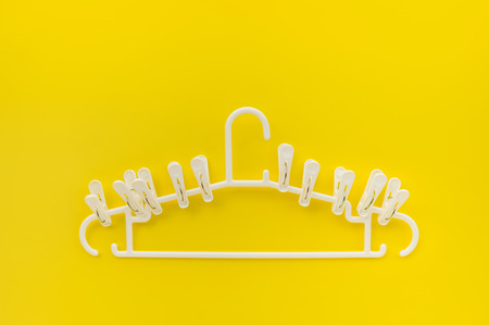 clothespins with hangers on yellow color background,copy spaceの写真素材