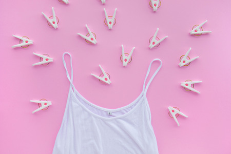 Undershirt with clothespin on pastel color background.wearing concepts ideasの写真素材