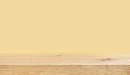 Empty of wood table top on yellow pastel color background.For montage product display or design key visual layoutの写真素材