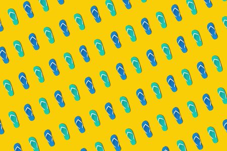 Colorful sandals in seamless photo on yellow background.design for holiday and summer concepts ideasの写真素材