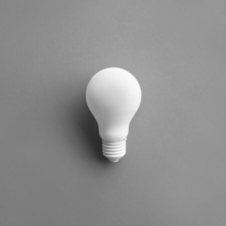 White lightbulb on pastel color background.Ideas creativity,inspiration,concepts.Flat lay design.