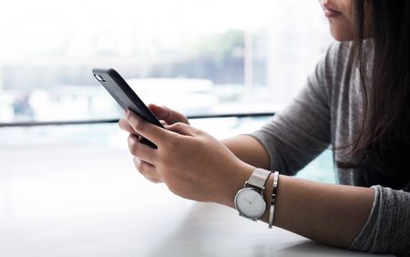 Close up female hand  holding smartphone
