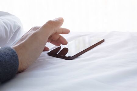 Male sleeping on bed with smartphone in morning.lifestyle concepts ideas
