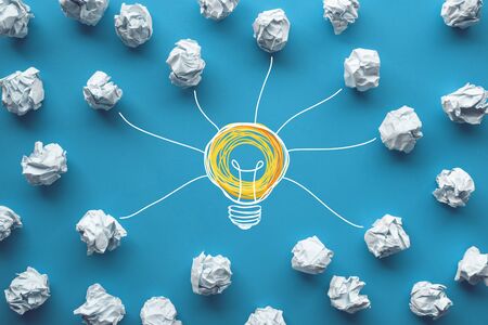 Creativity inspiration,ideas concepts with power of lightbulb and paper crumpled ball on color background.business or human performanceの写真素材