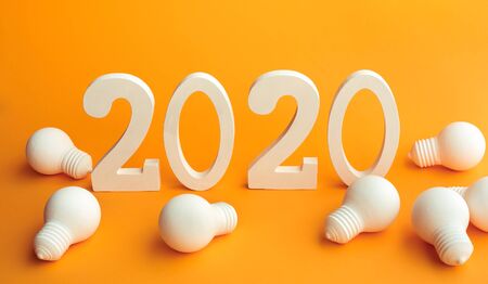 2020 creativity inspiration concepts with text nuber and lightbulb on color background.Business resolution,action plan ideas.glowing contentsの写真素材