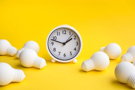 Time,dateline and creativity concepts with group of lightbulb and clock on pastel color background.Business solution.Performance of human.minimal style.の写真素材