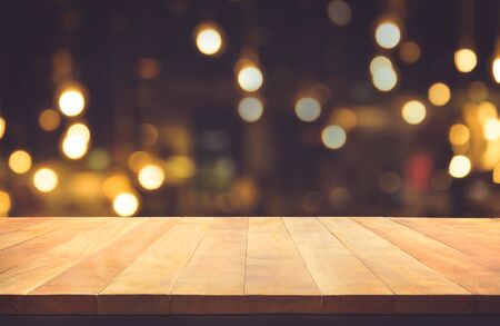 Empty of wood table top with blurred light gold bokeh abstract background.For montage product...