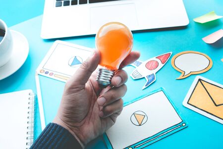 Start up idea concepts with light bulb in male hand on digital element paper art.