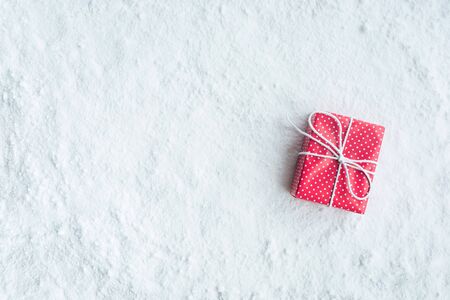 Gift box,present on snow background.For christmas concepts or new year,celebration ideas.Top viewの写真素材