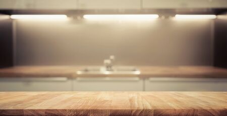 Wood table top on blur kitchen room background .For montage product display or design key visual layout.の写真素材