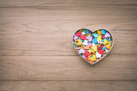 Colorful heart shape in box on wood table background.love, valentine,wedding concepts ideas
