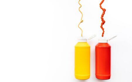 Bottles sauce splashes ( ketchup, mustard ) on white background.の写真素材
