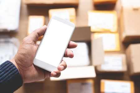 Online shopping concepts with youngman using smartphone on a lot of packag box.Ecommerce marke.Transportation logistic.Business retail marketの写真素材