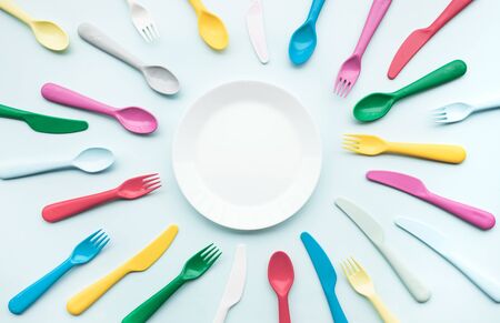 Top view of dish with colorful spoon and fork element on color table.flat lay designの写真素材