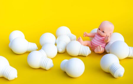Education and development of human concepts with baby kid and white lightbulb on blue color background.Iq and intelligence ideasの写真素材