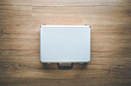 Above of metal briefcase(Box)on wooden floor background.Tool and security concepts ideas