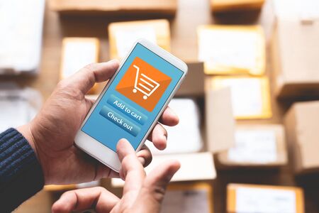 Online shopping concepts with youngman using smartphone for payment his order on a lot of product packag box.Ecommerce market.Business retail.modern life.の写真素材