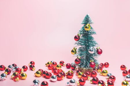 Christmas festival concepts ideas with cute pine tree and red ball ornament on pastel color background.For decoration celebrate card design.の写真素材