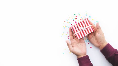 Celebration party and anniversary concepts ideas with young person hand giving gift box decoration...