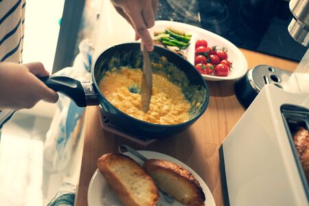 Cooking breakfast on kitchen counter bar in morning.Healthy food,simple eating lifestyle.の写真素材