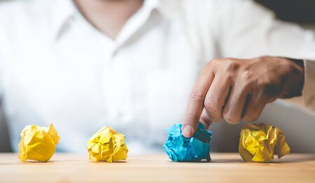 Idea and creativity concepts with person choosing paper crumpled ball.Think out of box.Business...