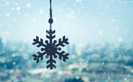 christmas ornament ( Snowflake ) hanging mobile with snowfall on blur outdoor landscape background.season and holiday conceptsの写真素材