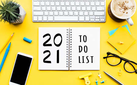 2021 new year with to do list  text on notepad with office accessories.Business...