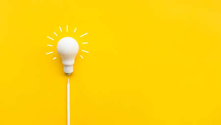 Business creativity and inspiration concepts with lightbulb and pencil on yellow background. motivation for success.think big ideasの写真素材