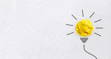 Ideas with yellow paper crumpled ball on wall background( lightbulb ).business creativity concept.